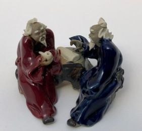 Ceramic Figurine Two Men Sitting On A Bench Holding a Pipe- 2.25" Color: Blue & Red